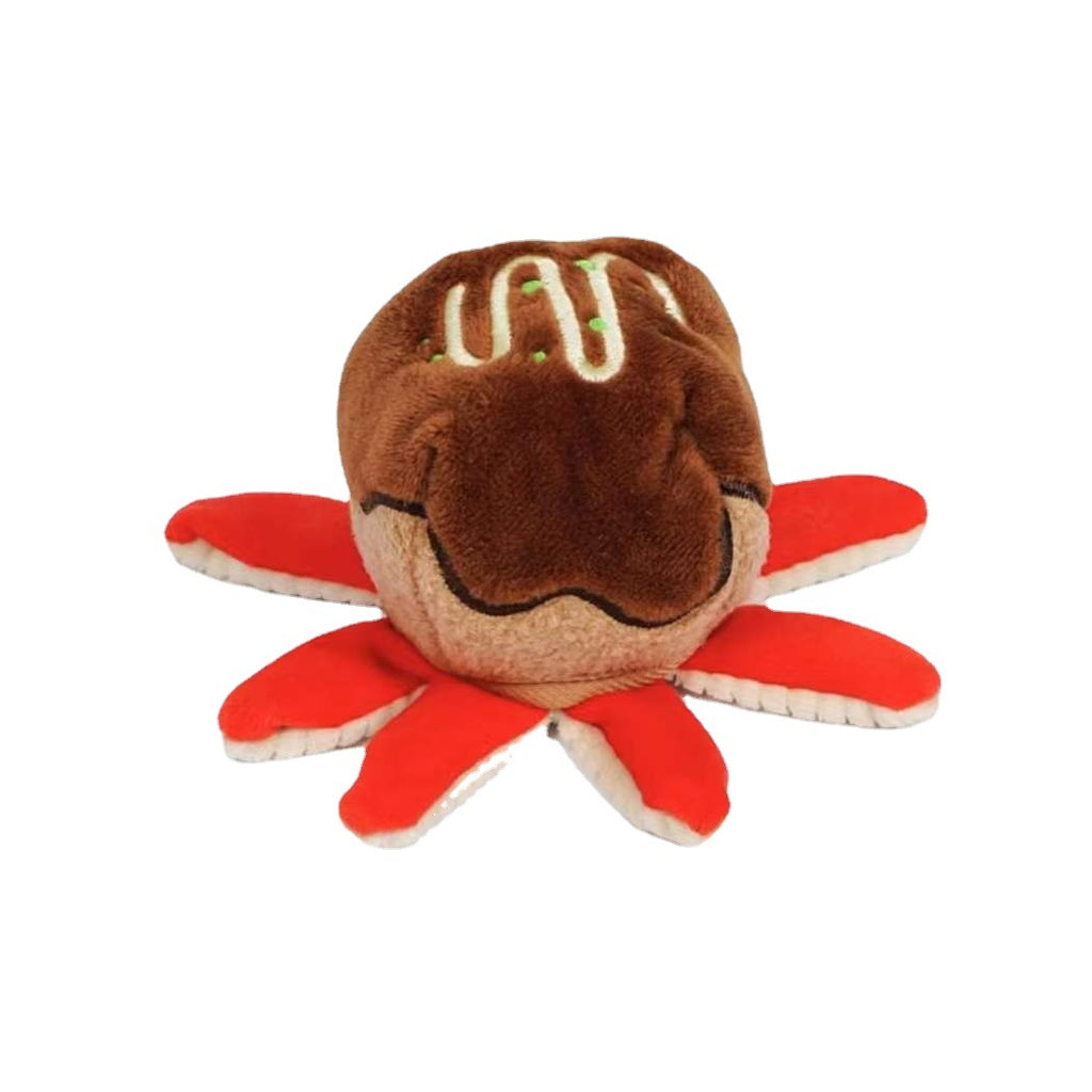 Single plush takoyaki toy with sauce-drizzle top and red octopus tentacle legs on white