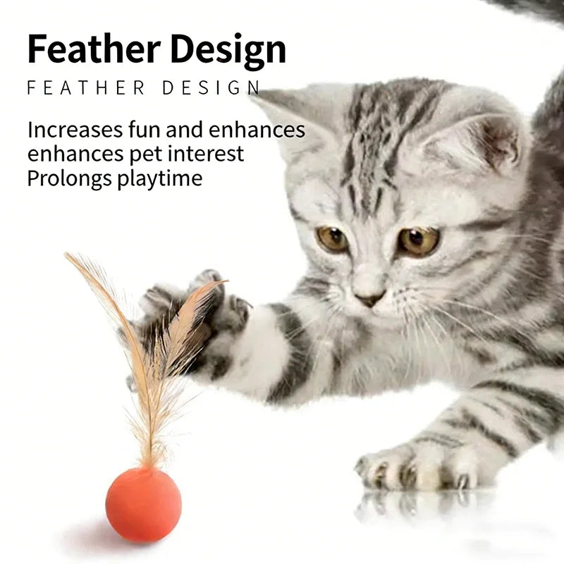 Kitten pouncing on an orange feather bouncer ball