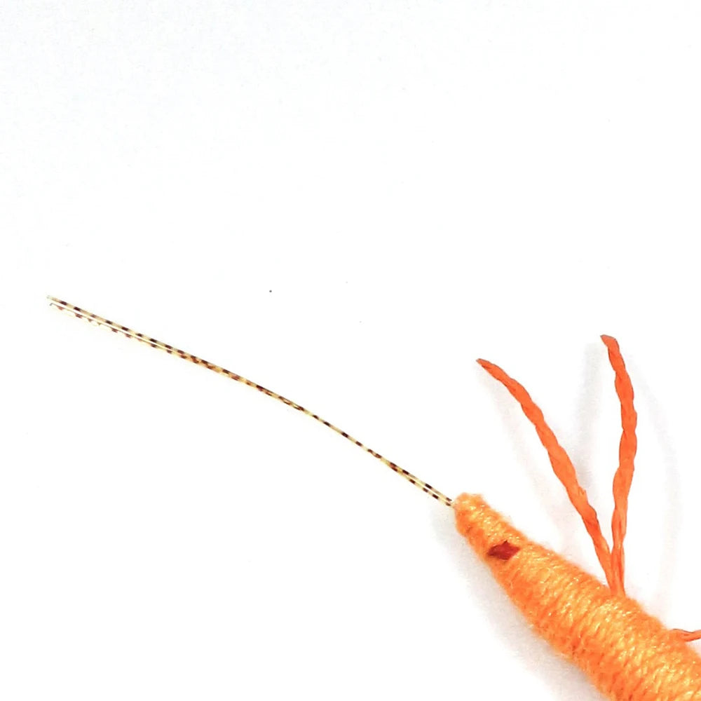 Close-up of a yarn-wrapped orange catnip prawn
