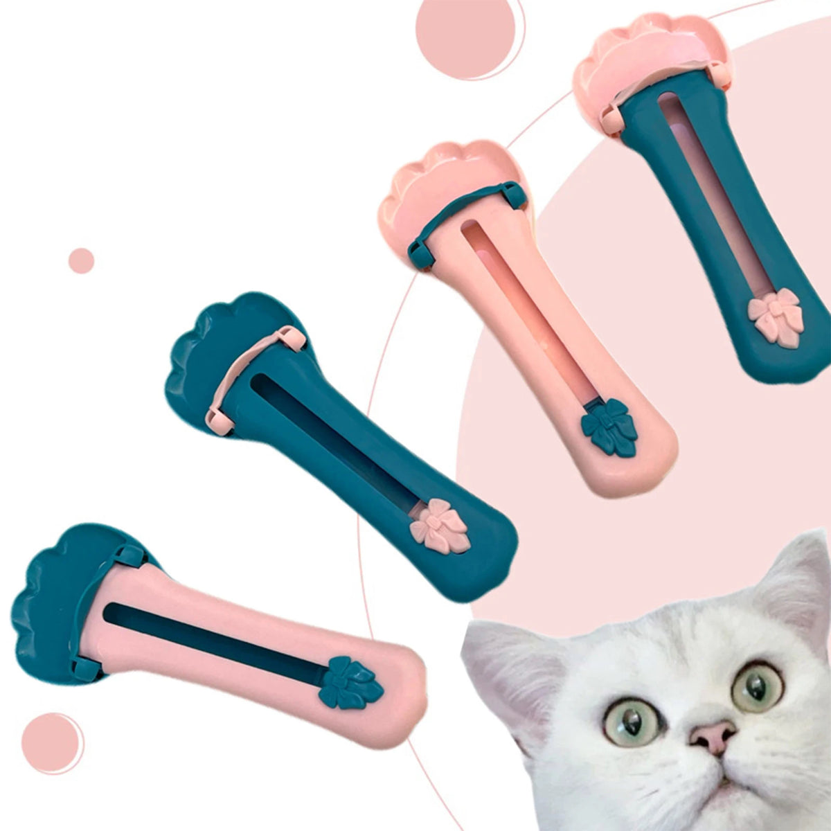Four paw squeezers in pink and teal with a curious cat
