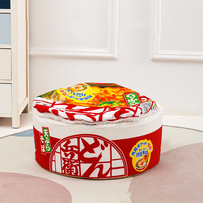 Red instant noodle cat bed in a cozy living room, ready for a cat nap