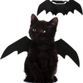 Black kitten wearing Mugi's Bat Wings, with the wings shown flat above