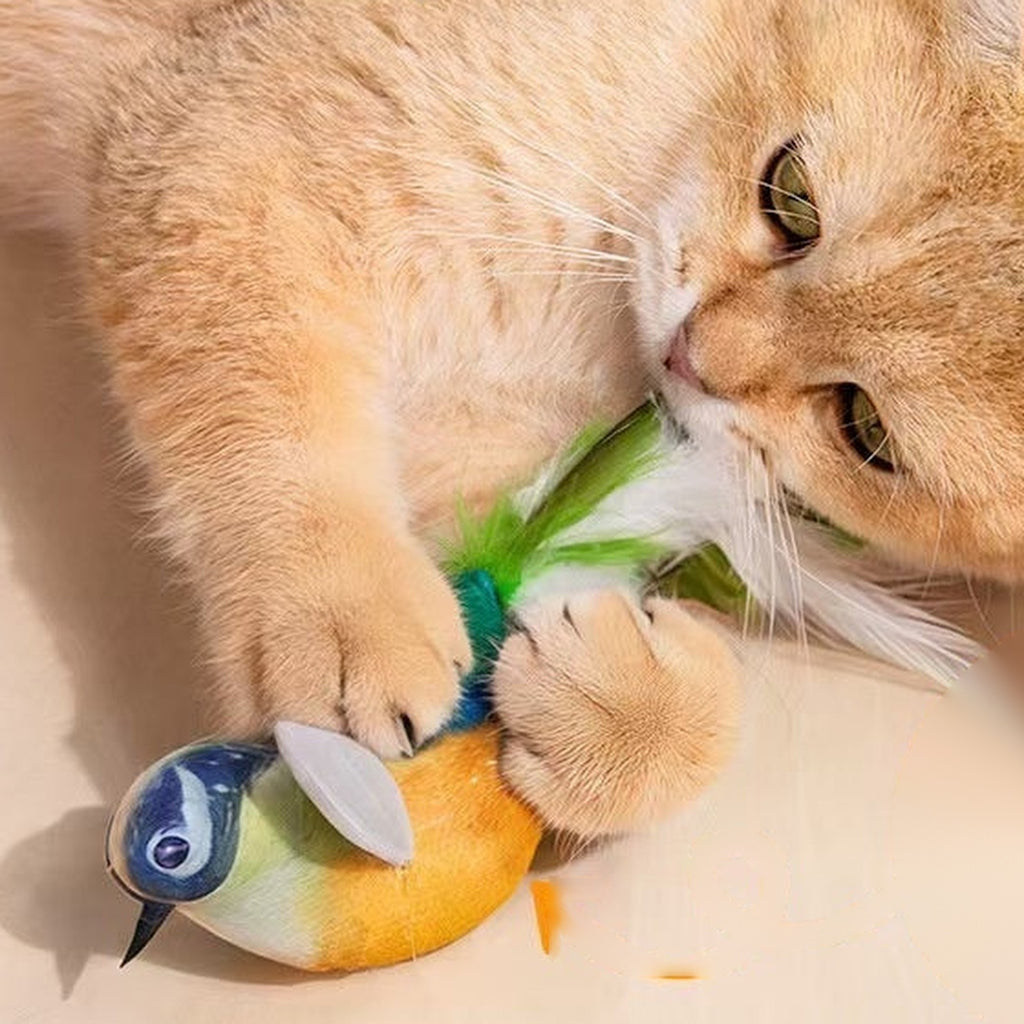 Ginger cat hugging the chirping bird cat toy with its built-in catnip pouch