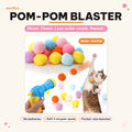 Mugi's Pom-Pom Blaster: cat toy launcher shooting soft pom-poms for a cat to chase. Shoot. Chase. Lose under couch. Repeat.