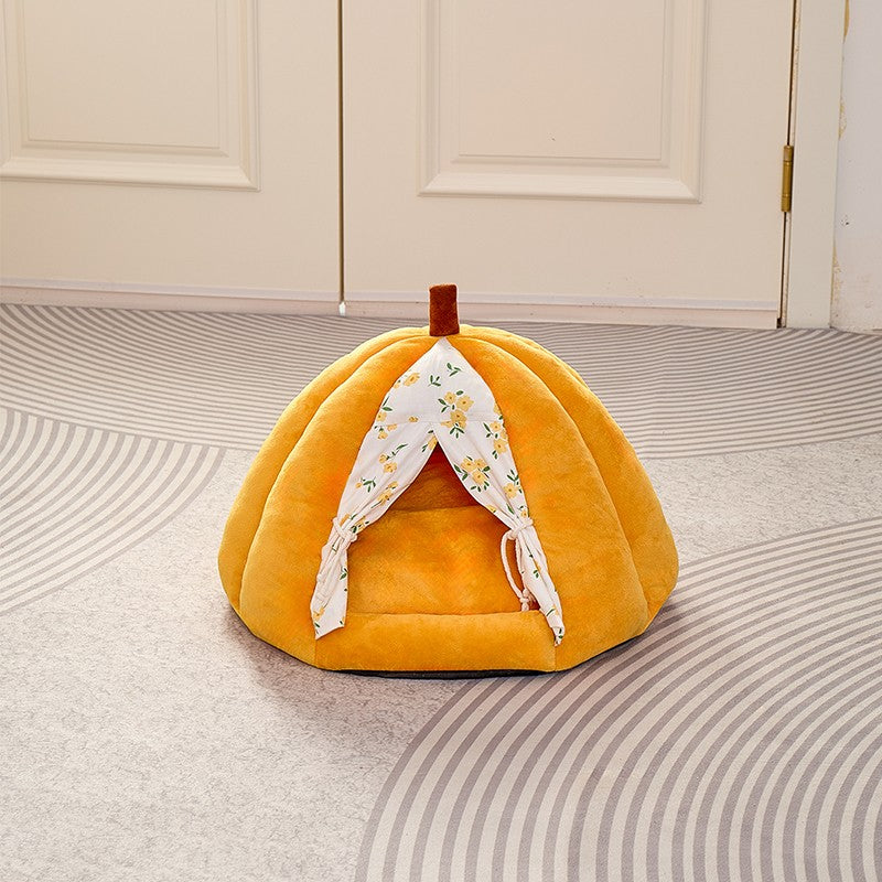 Plush pumpkin cat bed with its stem on top, front view