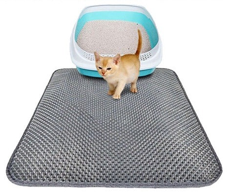 Gray double-layer cat litter mat in front of a litter box with a kitten