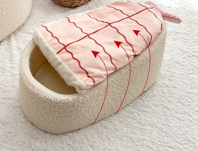 Sushi cat bed in a living room with the shrimp blanket lifting over the bed
