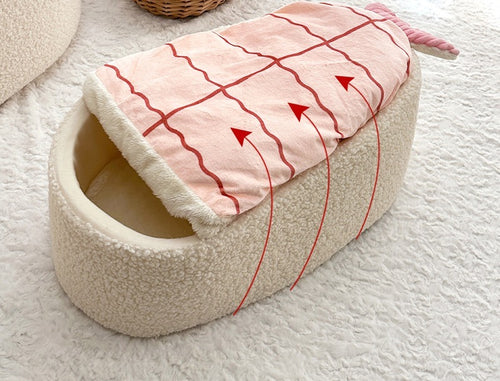 Sushi cat bed in a living room with the shrimp blanket lifting over the bed