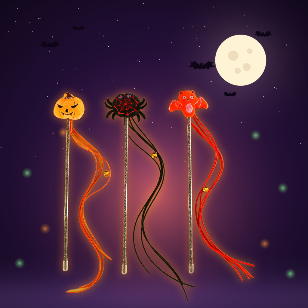 Pumpkin, spider and bat Spooky Teaser Wands on a moonlit Halloween night