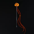 Pumpkin teaser wand with orange tassels and a bell