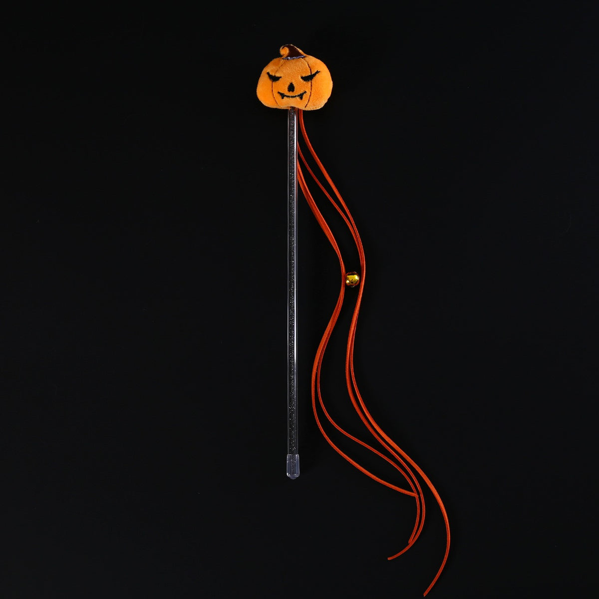Pumpkin teaser wand with orange tassels and a bell