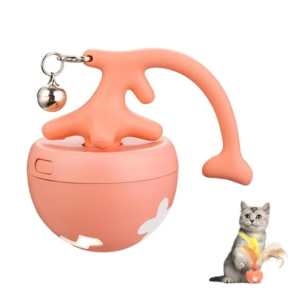 Mugi's Zoomie Ball in pink with tail and bell, kitten playing with it